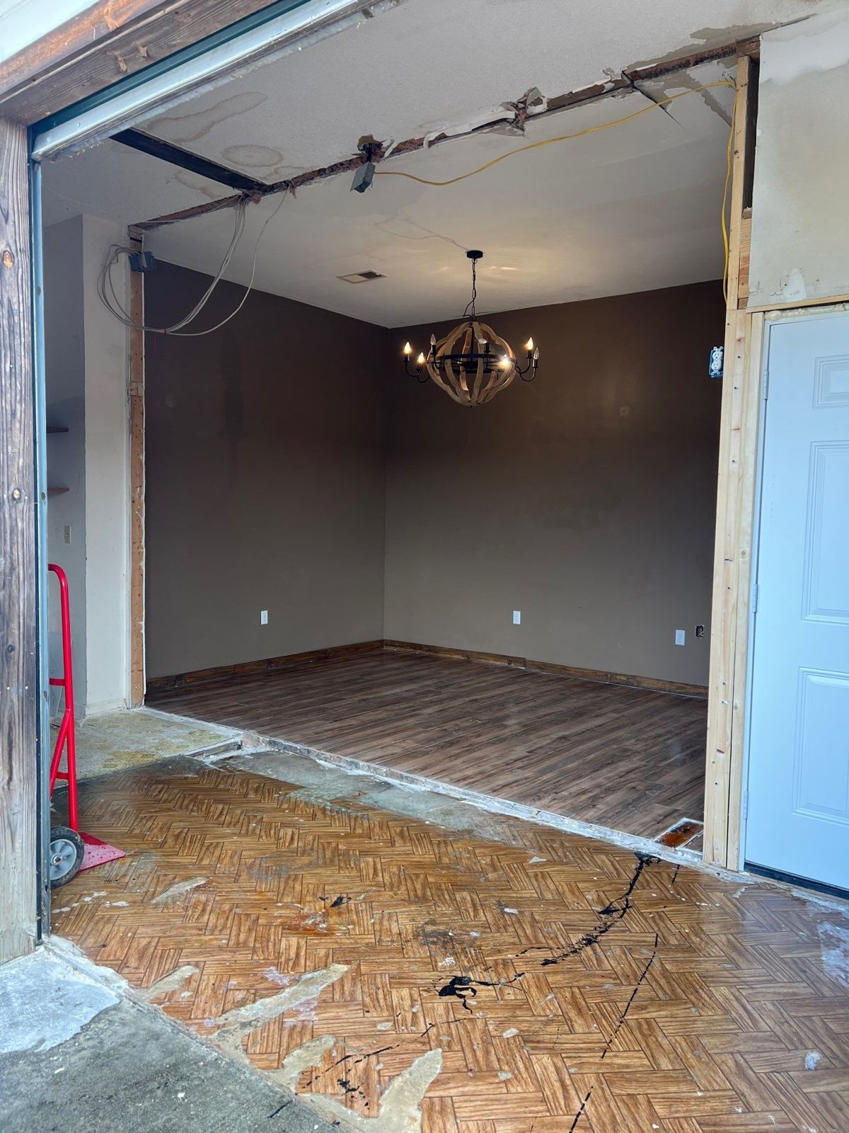 Wall opened between the old humidor area and the neighboring room, new flooring going in